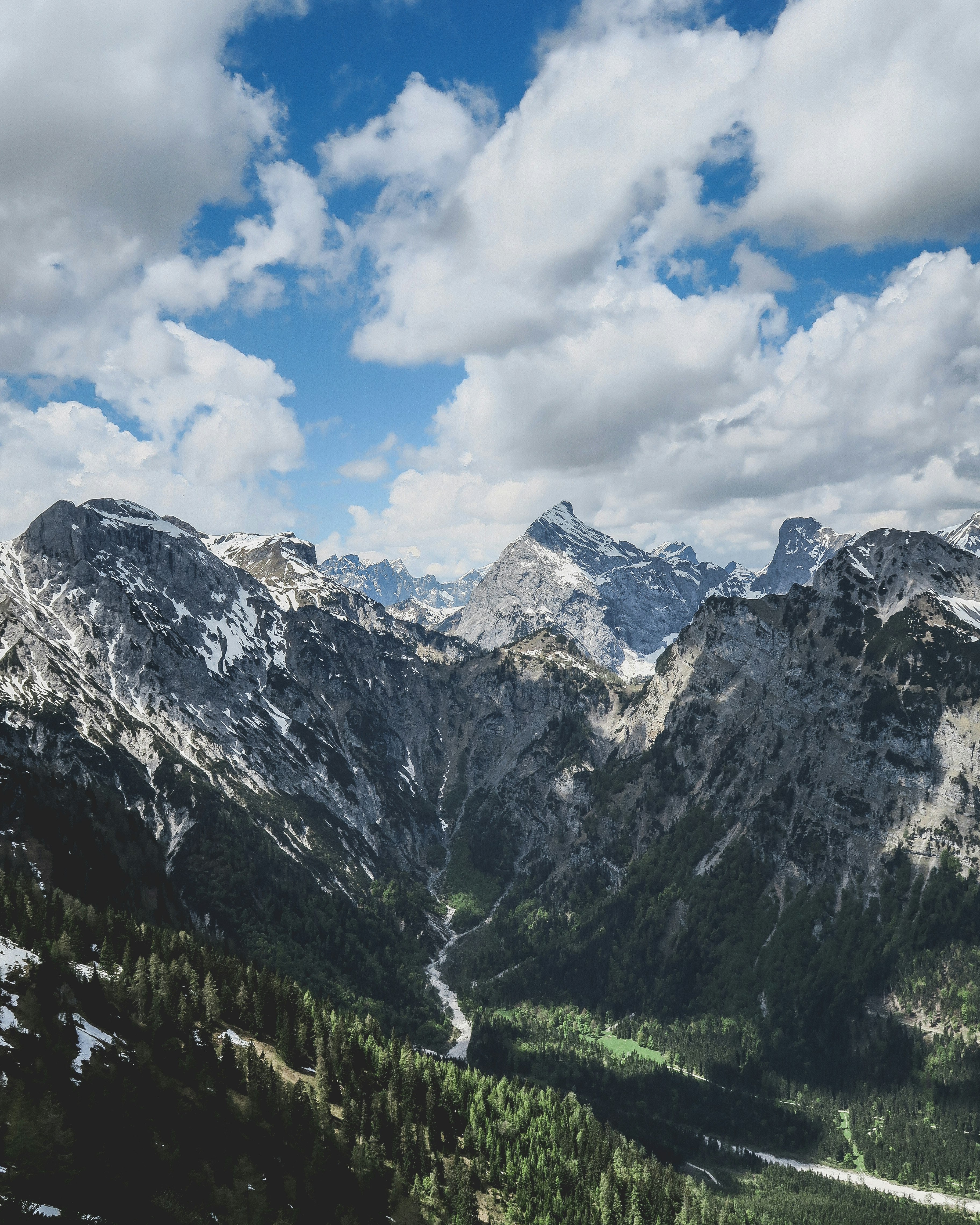 mountain range under cloudy sky during daytime