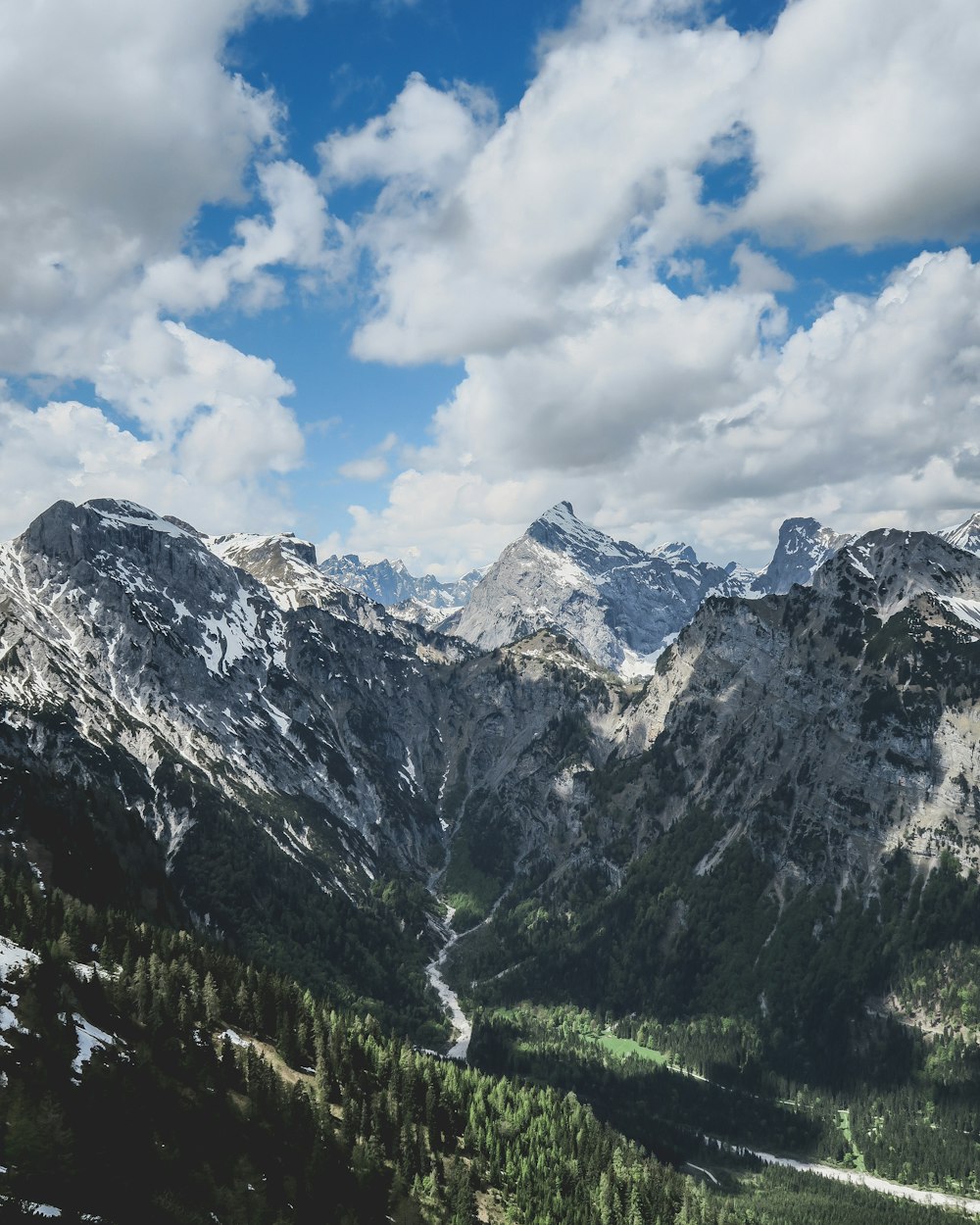 mountain range under cloudy sky during daytime