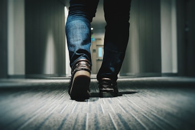 perspective and angle for photo composition,how to photograph feet in a hotel corridor; person walking on room
