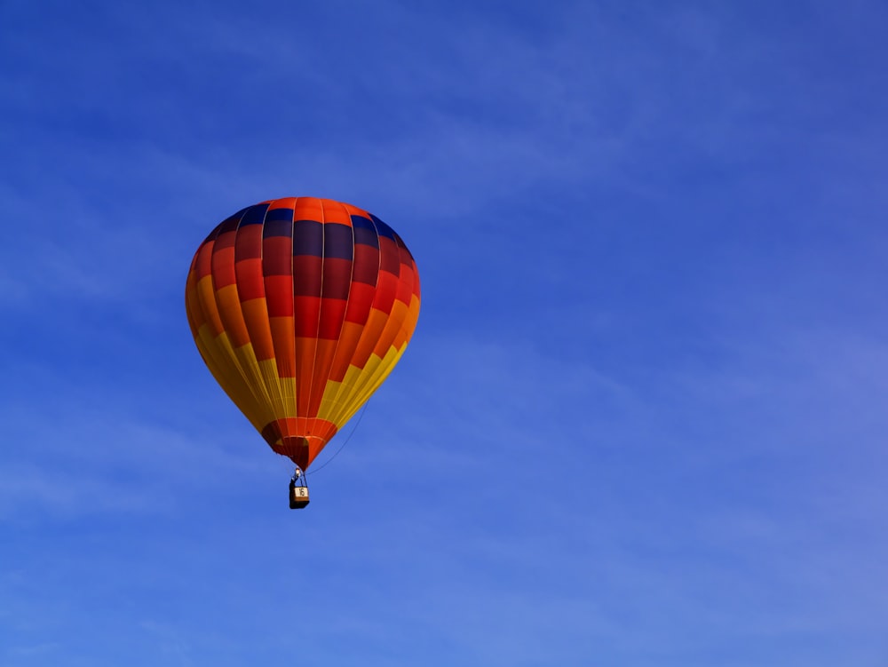 photo of red hot air balloon on sky