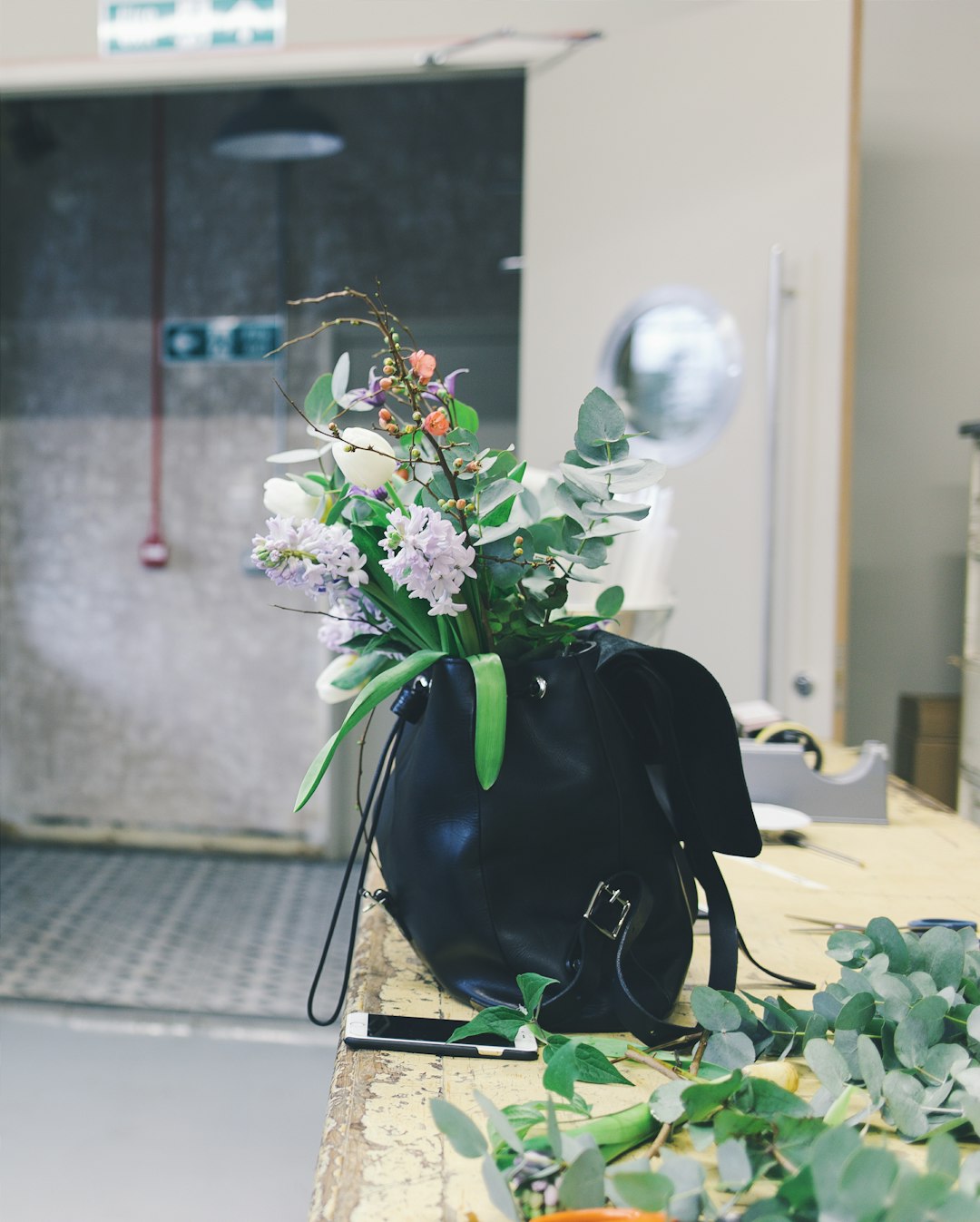 white and orange flowers in black leather backpack