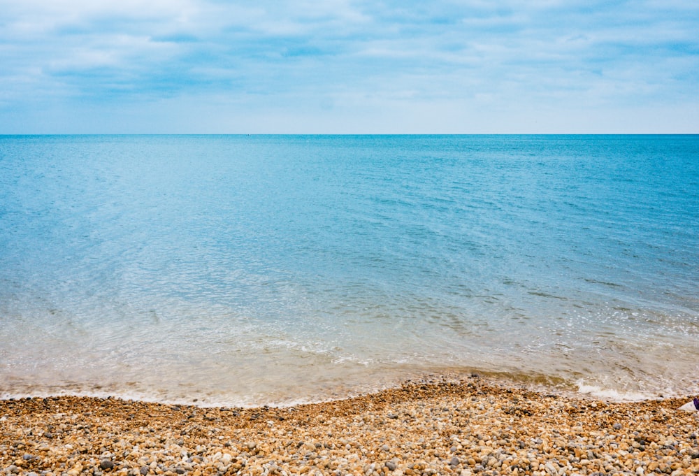 blue body of water under blue sky photography