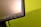 Close-up of a computer screen displaying a product page with a vivid green buy now button.