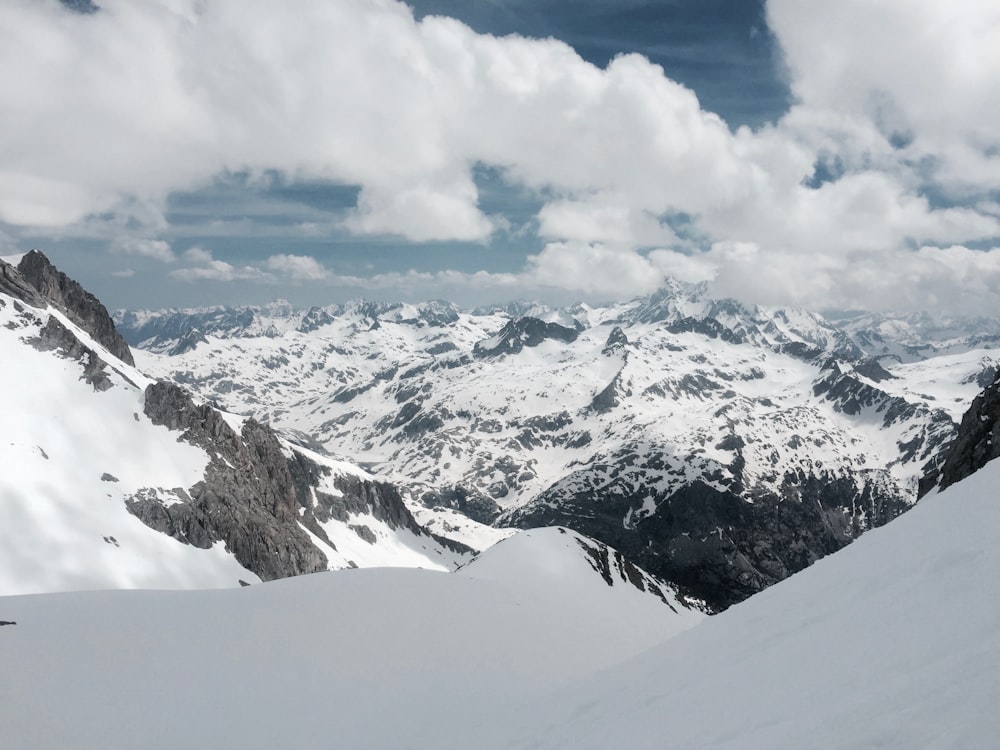 mountain alps under cumulus clouds