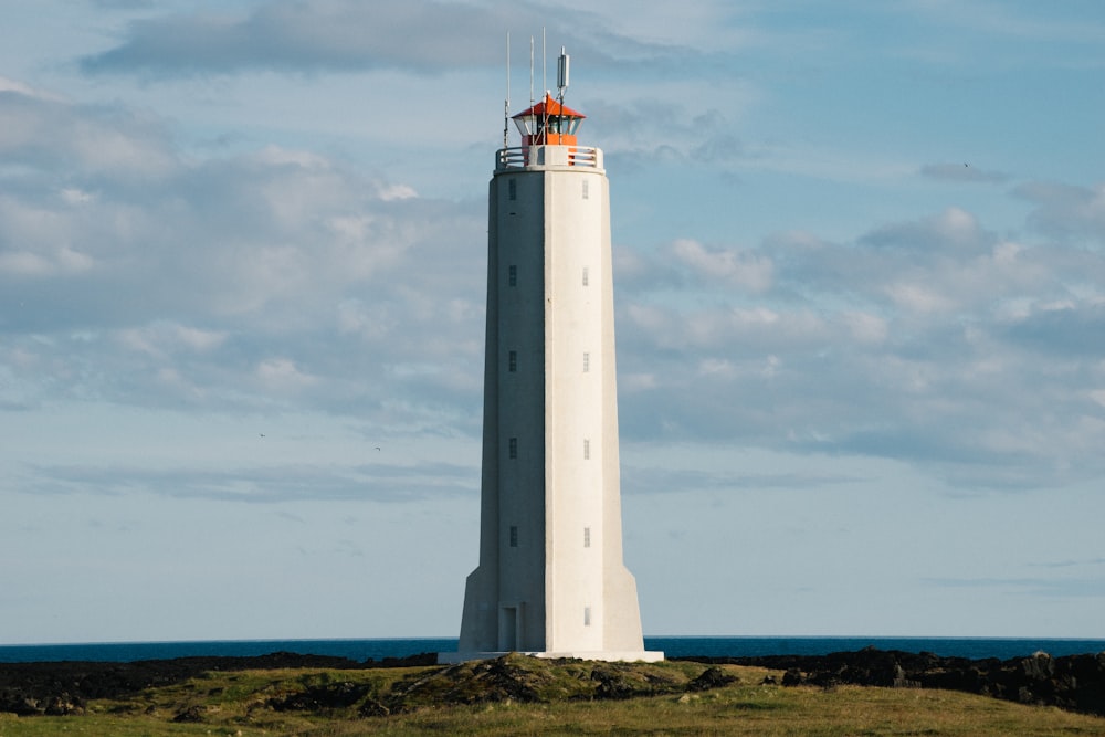 white lighthouse near body of water