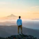 man standing on top of mountain