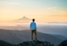 man standing on top of mountain