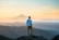 man standing on top of mountain