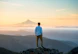 man standing on top of mountain