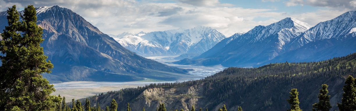 green mountain across body of water