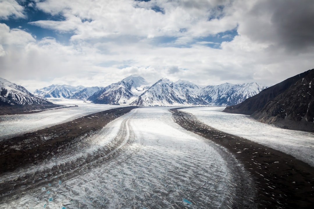 snowy mountain under white clouds, snow roads in Yukon Territory