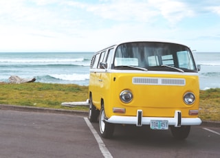 yellow Volkswagen T2 van on concrete road