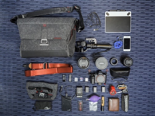 A creative flat lay of photography gear and social media notes on a green textured surface.