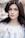 woman standing near white petaled flower