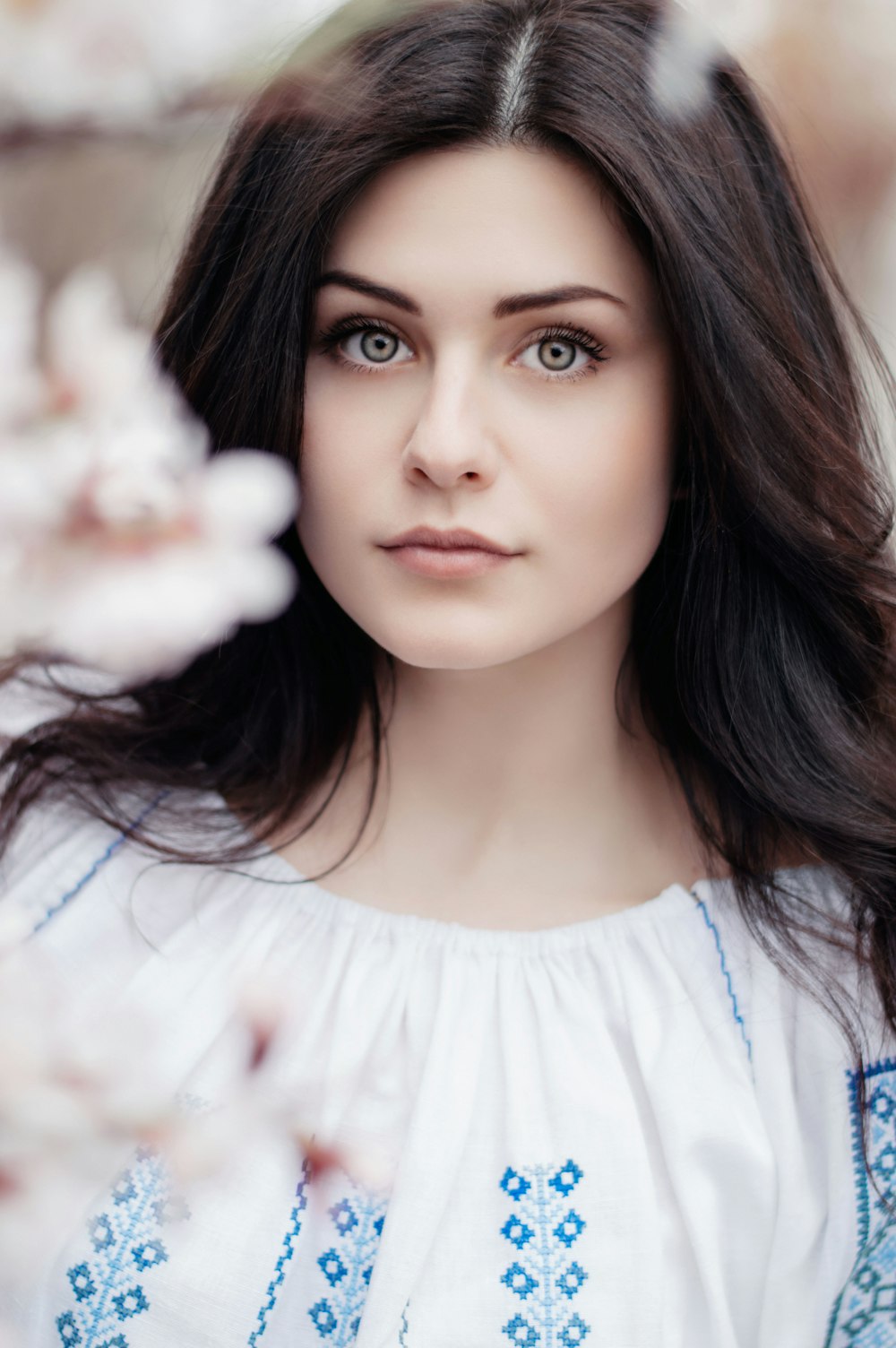 woman standing near white petaled flower