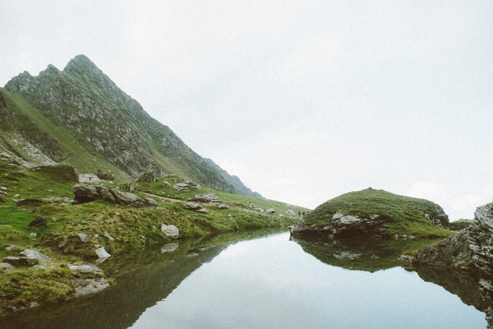 landscape photography of lake near hill