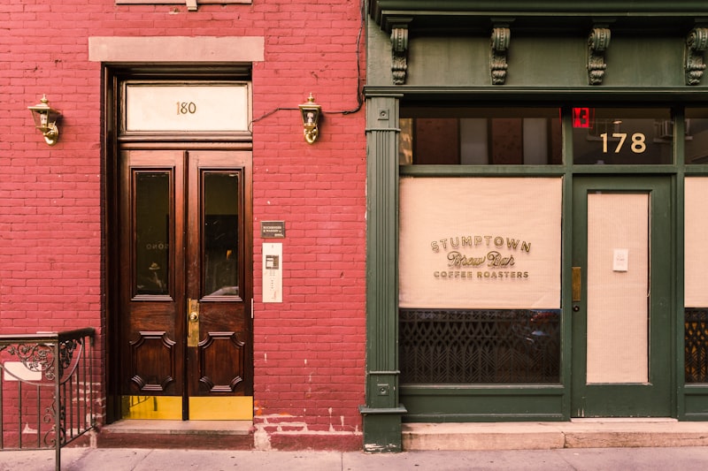 Row of independent storefronts on a city block, representing multiple business locations