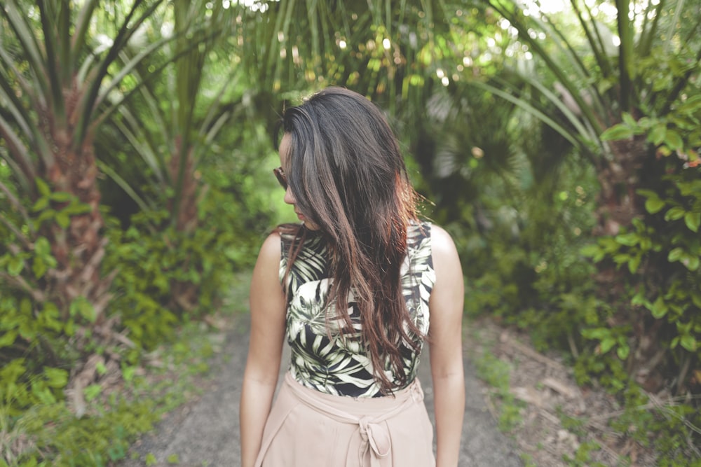 woman walking on forest trail looking downwards