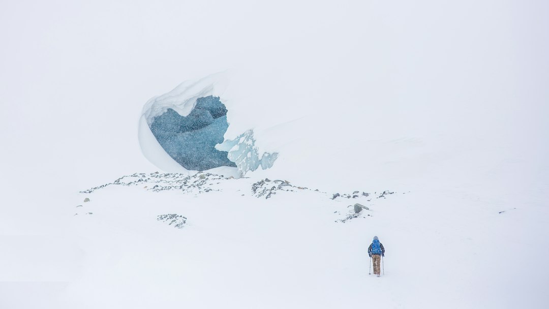 man skiing on mountain top, Hiker heading to ice cave