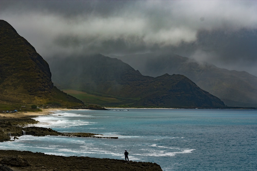 landscape photography of mountains near body of water