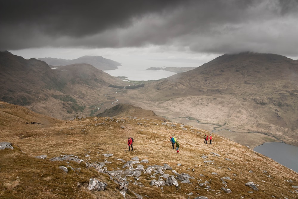 people standing on mountain peak