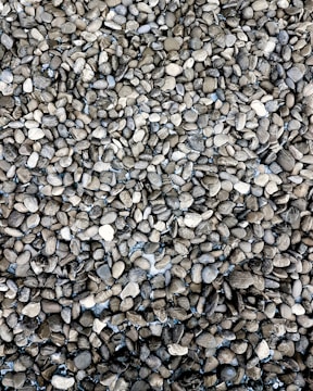 Close-up view of 20mm metal stones stacked neatly at a construction site.