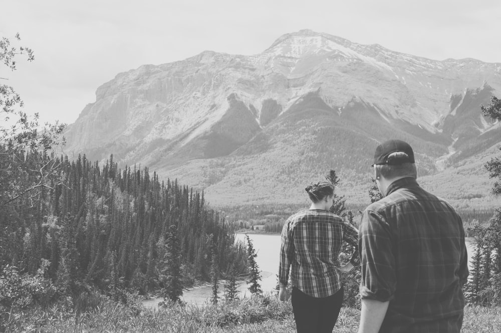 a couple of people that are standing in the grass