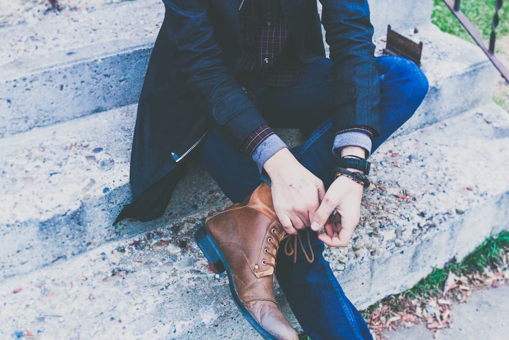 man sitting on concrete stair