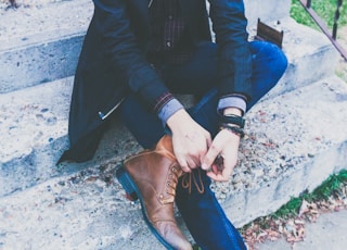 man sitting on concrete stair