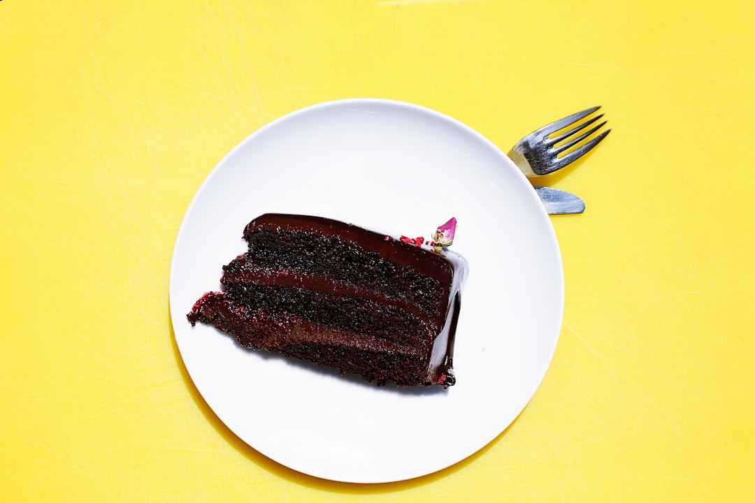 Plate of chocolate cake on a yellow background