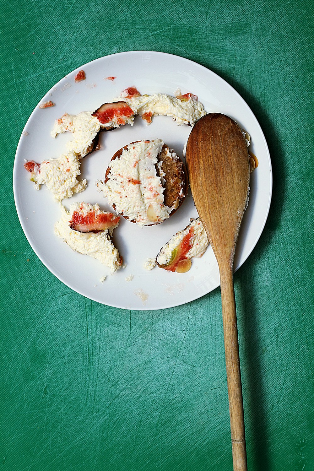 une assiette blanche garnie de gâteaux de crabe et d’une cuillère en bois