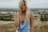 woman standing on top of a hill