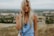 woman standing on top of a hill
