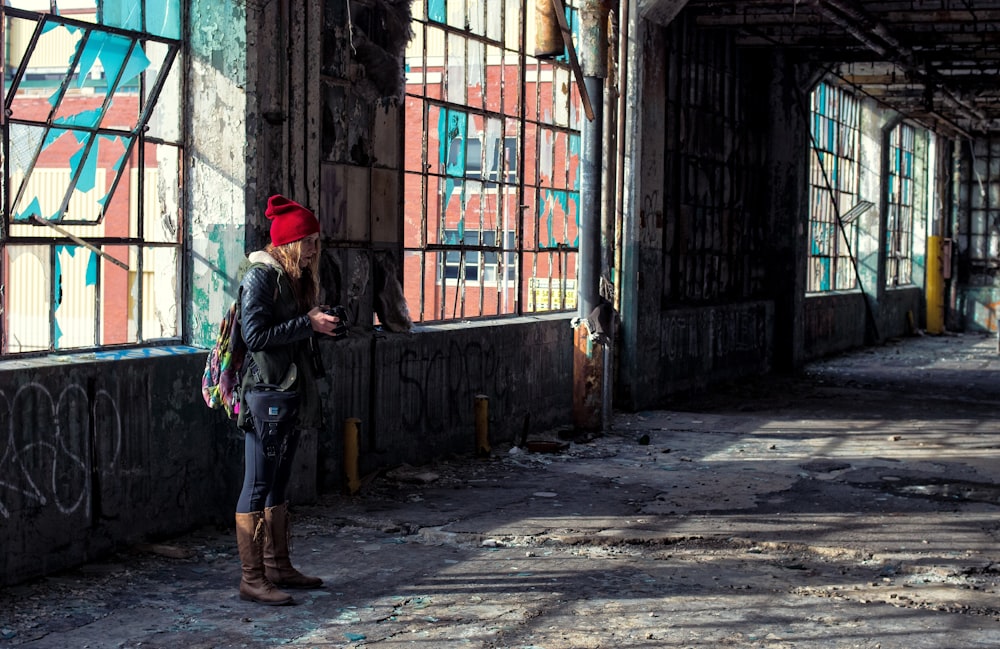 woman standing near building window