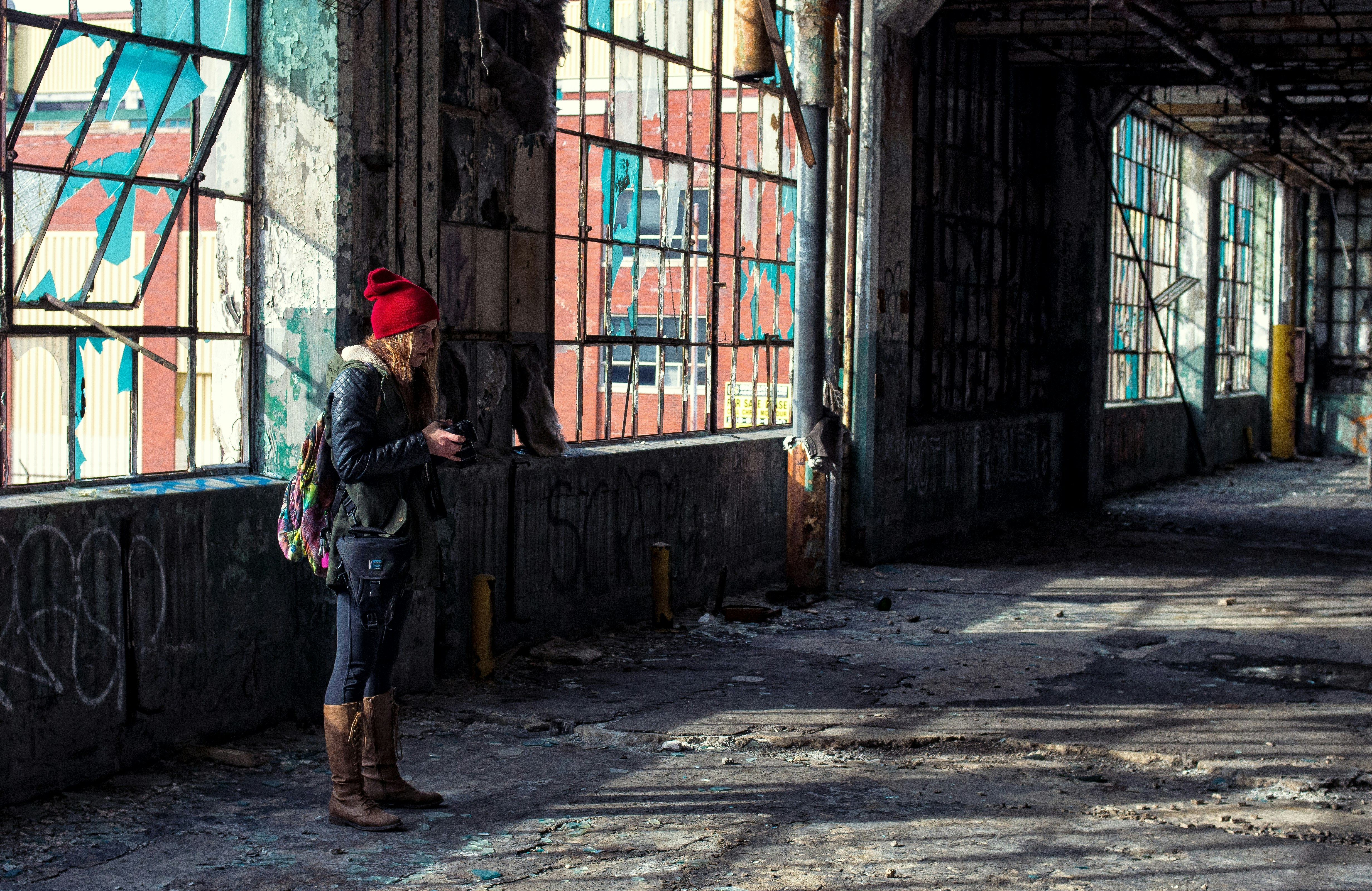 woman standing near building window