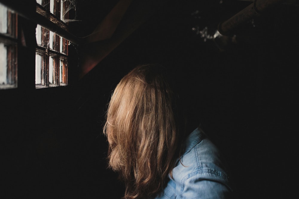 person sitting beside window