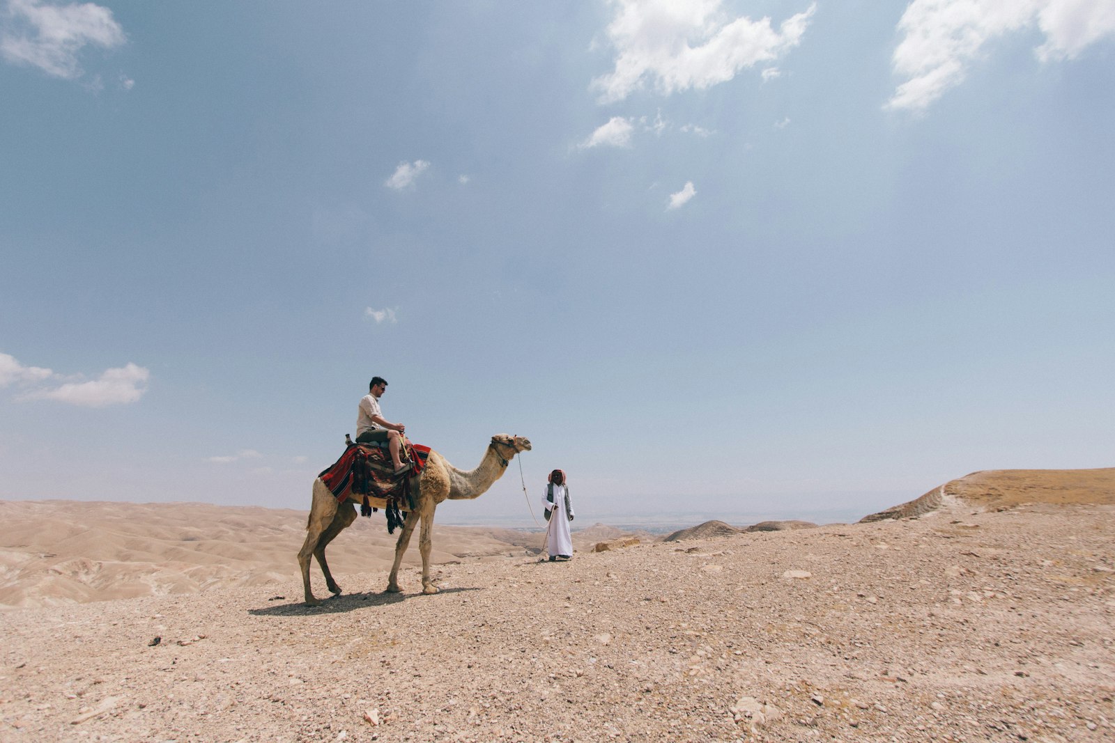 Canon EOS 550D (EOS Rebel T2i / EOS Kiss X4) + Canon EF-S 10-22mm F3.5-4.5 USM sample photo. Person ride on camel photography