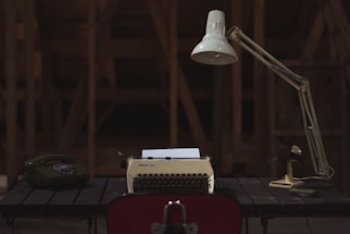 A cozy workspace with handcrafted music boxes and a vintage telephone.