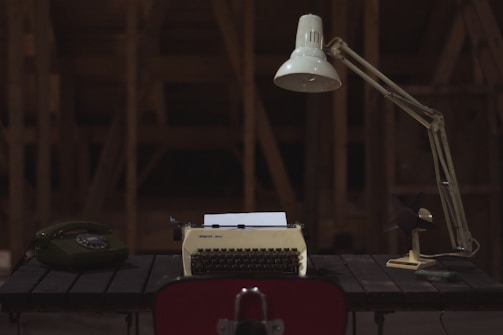 A cozy workspace with handcrafted music boxes and a vintage telephone.