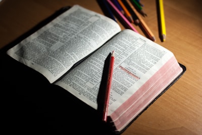 Close-up of colorful Bible activity materials spread out on a wooden table.
