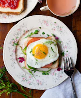 sunny-side up egg with bread beside fork
