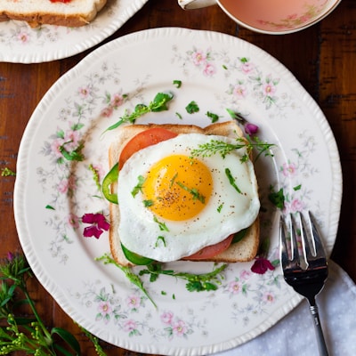 sunny-side up egg with bread beside fork