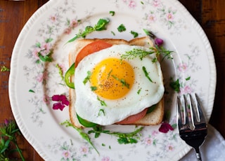 sunny-side up egg with bread beside fork