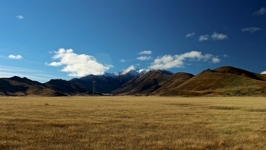 photo of grass field and mountains in Fairlie-Tekapo Road New Zealand
