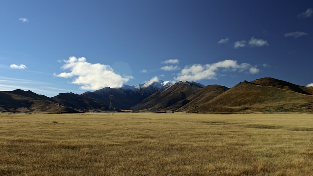 photo of grass field and mountains