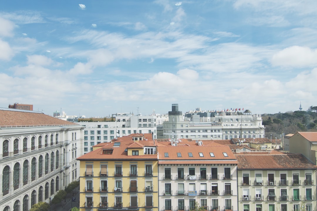 aerial view of concrete buildings and blue cloud sky, City with many buildings