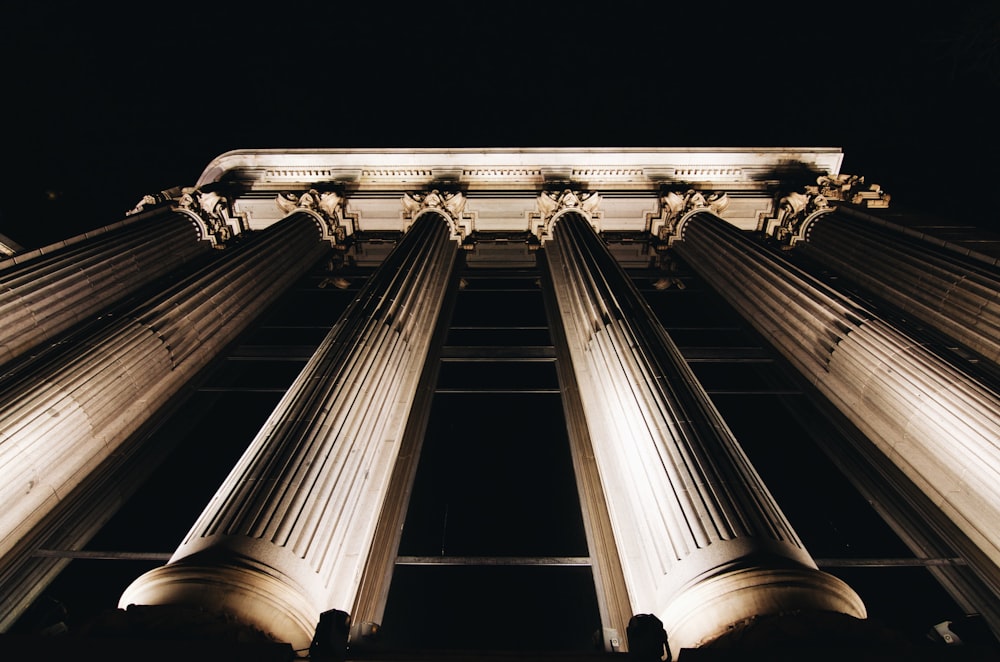 Staring up at the tall pillars in front of a courthouse.