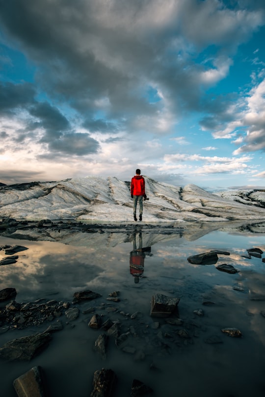 man standing near body of water of water in Matanuska Glacier United States