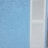 A textured blue stucco wall is situated next to a white louvered shutter.