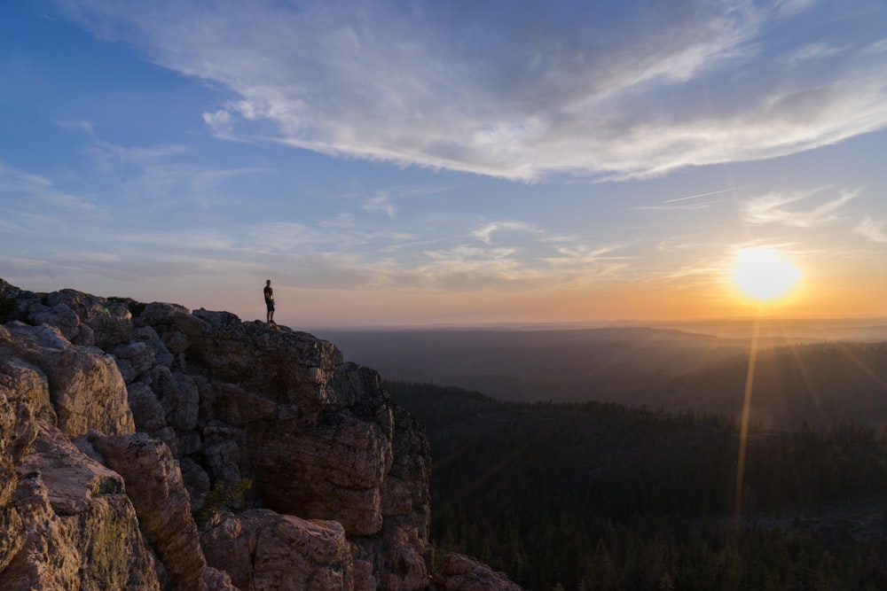 person standing on mountain cliff